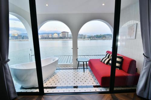 a bathroom with a view of the water and a tub at เลอค่าเชียงแสน Le Quar Cafe BistroBed & Breakfast in Golden Triangle