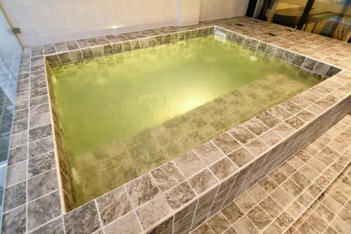 a pool of water in a bathroom with tiles at เลอค่าเชียงแสน Le Quar Cafe BistroBed & Breakfast in Golden Triangle