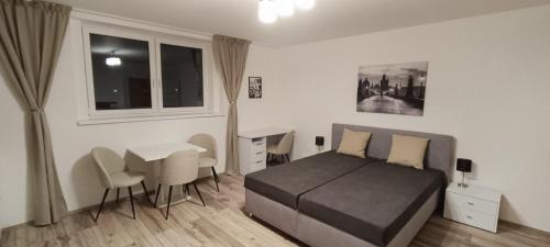 a bedroom with a bed and a table and chairs at Aparthotel Praha in Prague