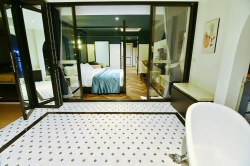 a bedroom with a bed and a large mirror at เลอค่าเชียงแสน Le Quar Cafe BistroBed & Breakfast in Golden Triangle