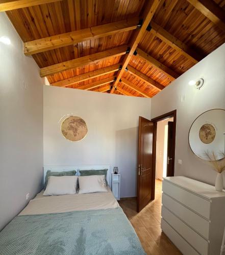 a bedroom with a bed and wooden ceilings at Salitzo Apartment Palairos in Paleros