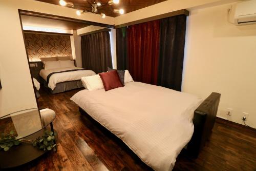 Ένα ή περισσότερα κρεβάτια σε δωμάτιο στο Maison Sapporo
