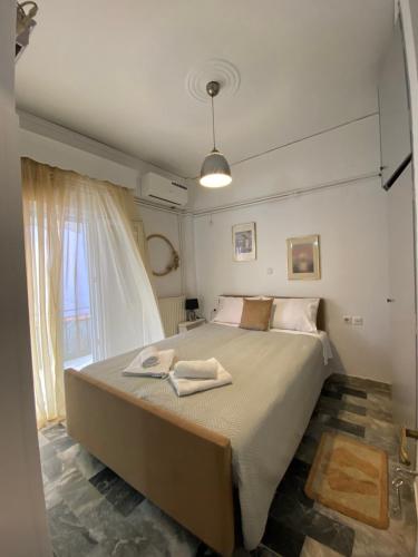 a bedroom with a bed with two towels on it at Maria,s house in Petra