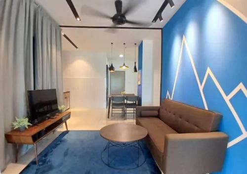 a living room with a couch and a table at ITCC Manhattan by IGVC in Penampang