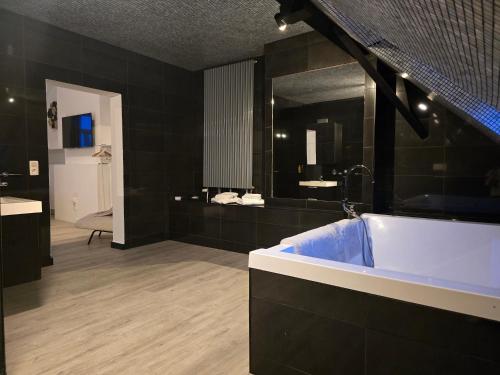 a bathroom with a blue tub and a mirror at 8z dreamz 4 in Ghent