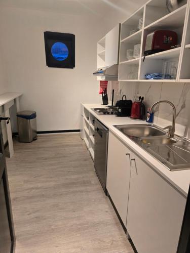 a kitchen with white cabinets and a sink and a counter at 8z dreamz 4 in Ghent