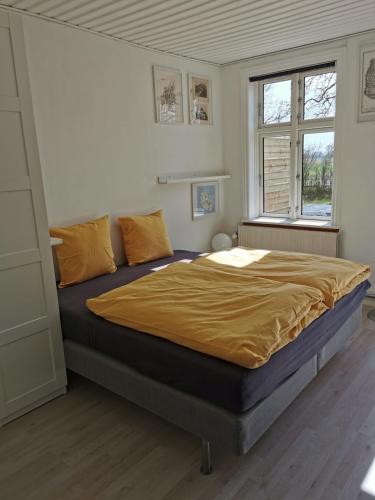a bedroom with a large bed in a room at Apple Blossom Studio - near Rønne and Beach in Rønne