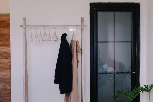 a closet with a black dress hanging on a rack at Lily house kedungu in Tabanan
