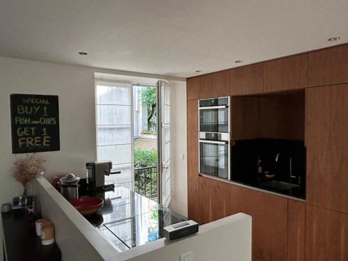 une cuisine avec un comptoir en verre et une fenêtre dans l'établissement New 100m2 3-Bedroom Flat in Paris 6th St Germain-des-Près, à Paris