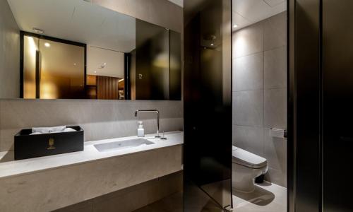 a bathroom with a sink and a toilet and a mirror at Hotel Mayotte in Uiwang