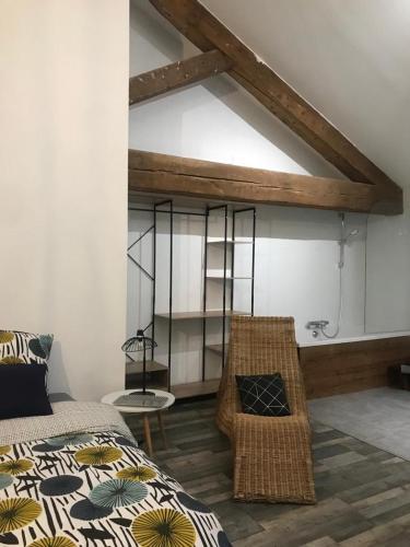 a room with a bed and a shelf in a room at Matin de Saône in Fontaines-Saint-Martin