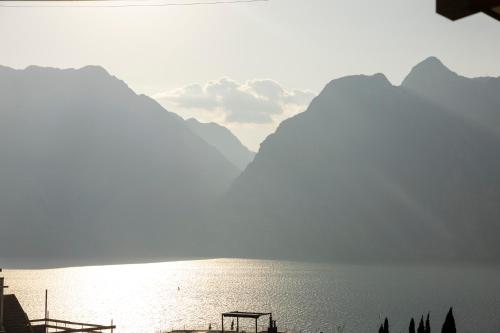 a view of a body of water with mountains in the background at Hi Hotels Torbole - Heated Outdoor Pool & Spa in Nago-Torbole