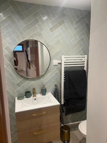 a bathroom with a sink and a mirror at Croix Rousse in Lyon