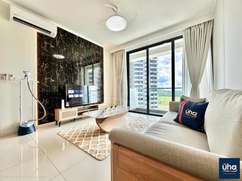 a living room with a couch and a large window at Macrolink Medini by RR JBcity in Nusajaya