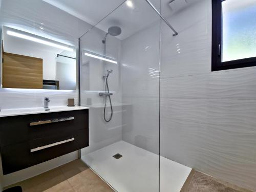 une salle de bain blanche avec une douche et un lavabo dans l'établissement Le Duplex Charme des Amandiers - Air conditioning - Sea view, au Lavandou