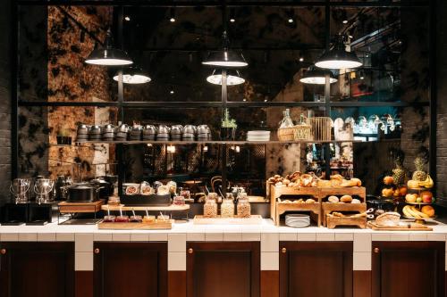 a bakery counter with a lot of different types of bread at Ruby Ella Hotel Cologne in Cologne