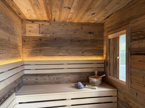 a sauna in a wooden cabin with a window at Aloha Suite - Schladming Dachstein in Haus im Ennstal