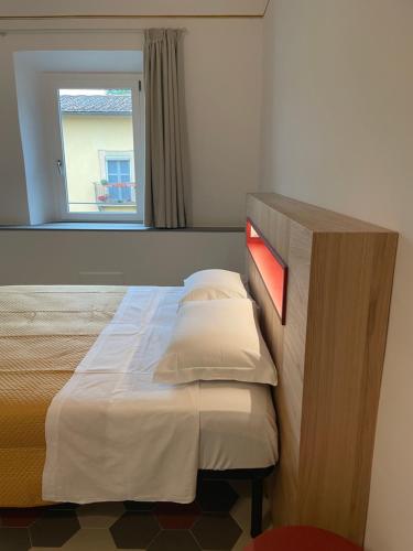 a bed in a room with a window at Il Genio - Residenza D'Epoca in Pisa