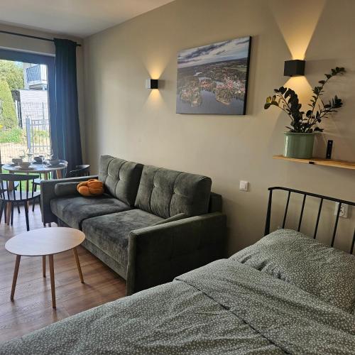 a living room with a couch and a table at Babie lato Łagów in Łagów