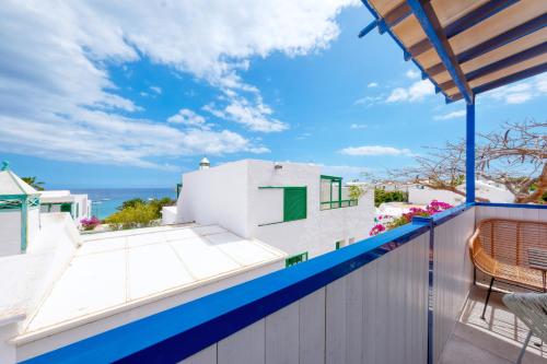a view of the ocean from the balcony of a house at Barraquito - Pool - 100M to Playa de Las Cucharas By Lanzarote Vacation Homes in Costa Teguise