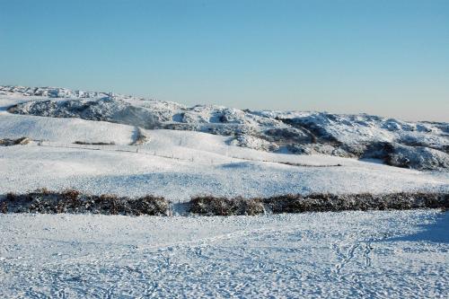 a snow covered hillside with snow on it at Cosy Seaside Cottage Baltimore in Ballylinchy