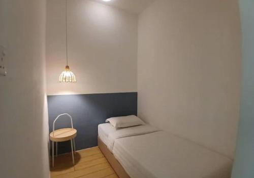 a small bedroom with a bed and a table at ITCC Manhattan by IGVC in Penampang