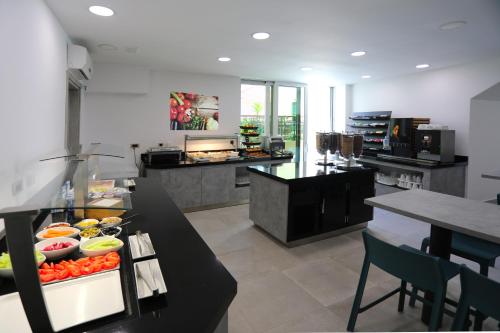 a kitchen with a counter with fruits and vegetables on it at Hotel - Teranea City Hvar in Hvar