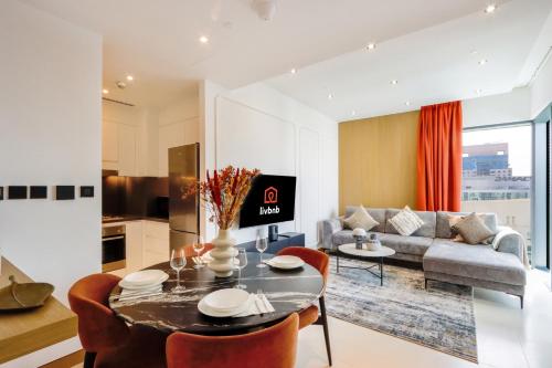 a living room with a table and a couch at 1BR Gem with Stunning Marina Views, Close to Metro in Dubai