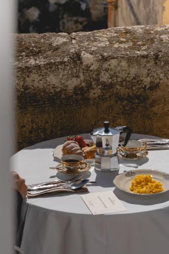 a table topped with plates of food on top at Sant'Angelo, Matera - Small Luxury Hotels in Matera