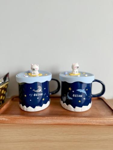 two coffee mugs sitting on a wooden shelf at Flamingo Hai Tien in Hoằng Hóa