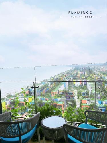 a table and chairs with a view of a city at Flamingo Hai Tien in Hoằng Hóa