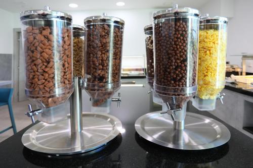 three food processors filled with nuts on a counter at Hotel - Teranea City Hvar in Hvar