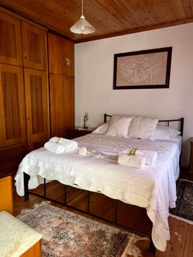 a bedroom with a bed with towels on it at Dora's House in Panayia