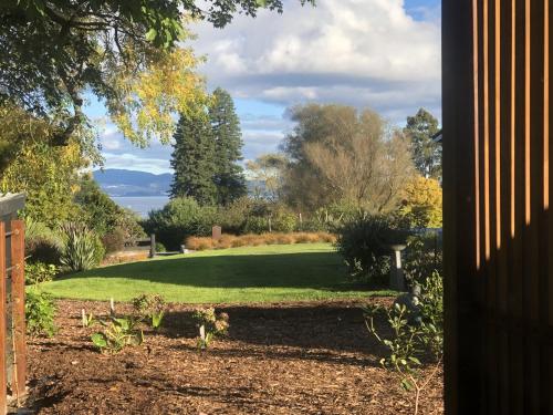 a view of a garden from a house at Hamurana Roost in Rotorua