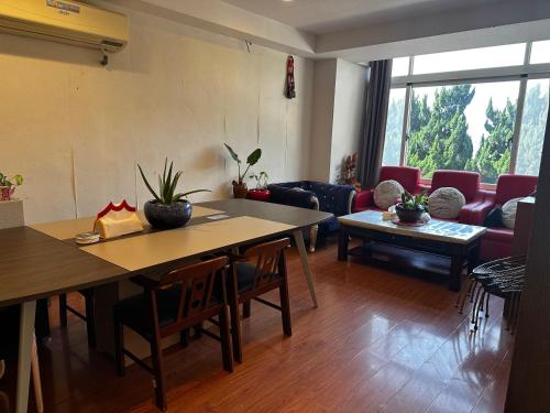 a living room with two tables and a couch at 卡蹓英雄館 in Ma-tsu