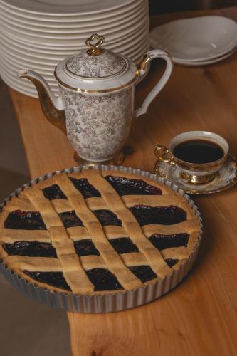 a pie on a table with a cup and a tea pot at Sant'Angelo, Matera - Small Luxury Hotels in Matera
