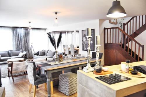 a kitchen and living room with a table and chairs at 4on Pebbles Holiday Home in Swakopmund