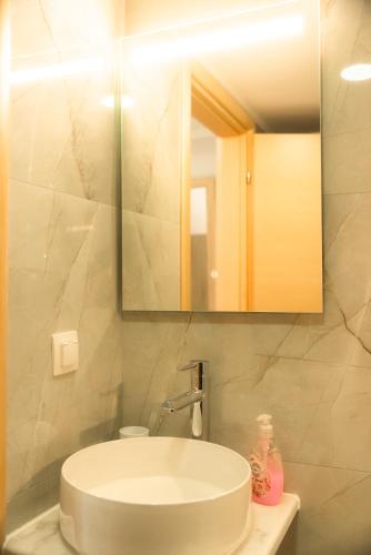 a bathroom with a sink and a mirror at Aktis Sea View Studios in Perea
