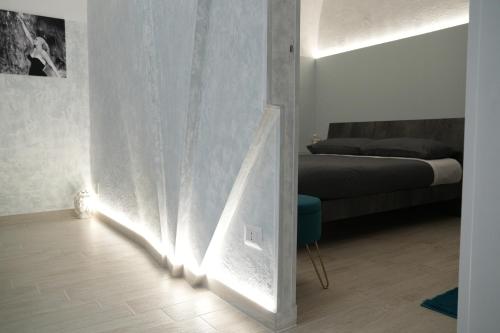 a living room with a bed and a wall with lights at La Dolce Vita - Casa Vacanze in Laterza