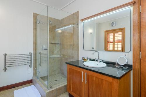 a bathroom with a sink and a glass shower at San Lameer Villa 14304 - 5 Bedroom Luxury - 10 pax - San Lameer Rental Agency in Southbroom