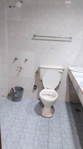 a bathroom with a toilet and a sink at Susan Hotel Seafront in Sandakan