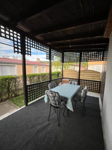 a patio with a table and chairs on a deck at Villa Lenka Sokobanja in Soko Banja
