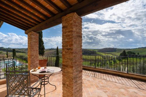 a patio with a table and a balcony with a view at Villa Petriolo - Small Luxury Hotels of the World in Cerreto Guidi