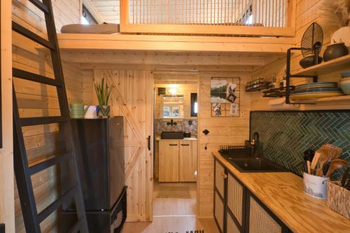 a kitchen with wooden walls and a wooden counter top at Tiny House Rhön- Natur & Komfort in Buttlar