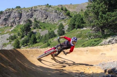 a person riding a bike on a dirt road at Logement entier, plein sud, pied des pistes, Chamrousse 1650 in Chamrousse