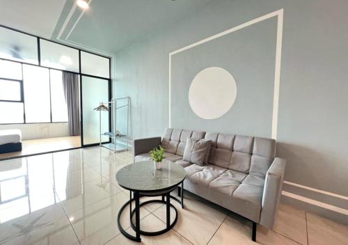 a living room with a couch and a table at ITCC Manhattan by IGVC in Penampang