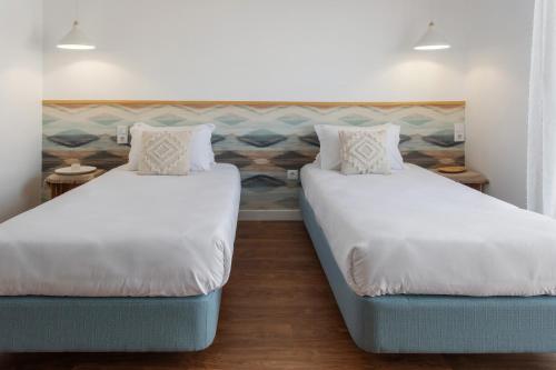 two beds in a room with two pillows at Quinta dos Raposos- Nazaré Portugal in Nazaré
