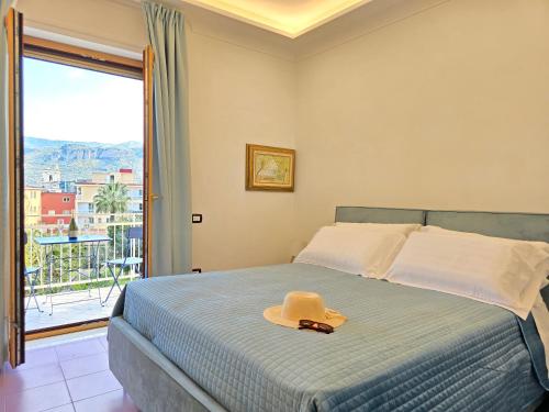 a bedroom with a bed with a hat on it at Casa Evelina in Sant'Agnello
