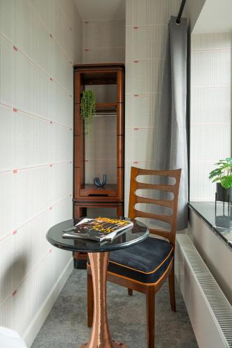a table and a chair in a room at Freshly Renovated Stay w kitchen and bathroom in Tilburg