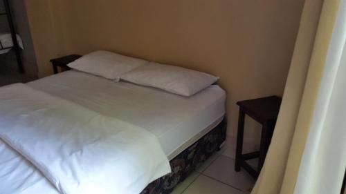 a bed with two pillows on it in a room at Accoustix Backpackers Hostel in Johannesburg